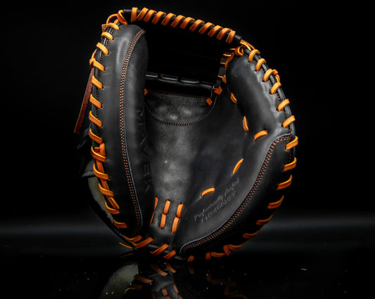 Black leather catcher's mitt with tan laces and stitching