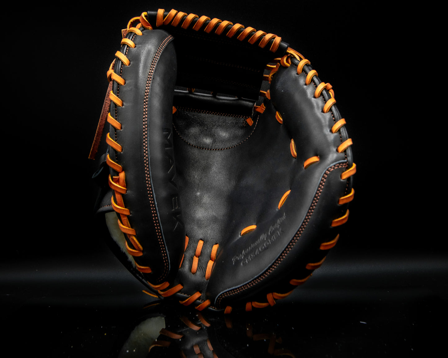 Black leather catcher's mitt with tan laces and stitching