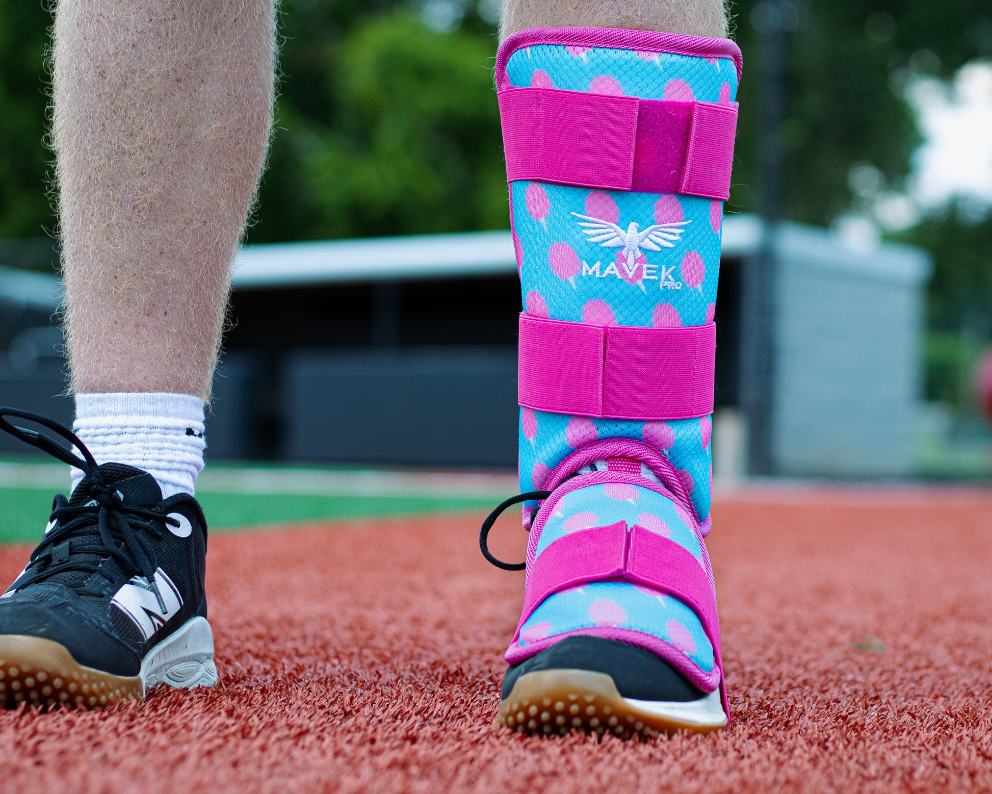 ballplayer wearing cotton candy leg guard on turf field