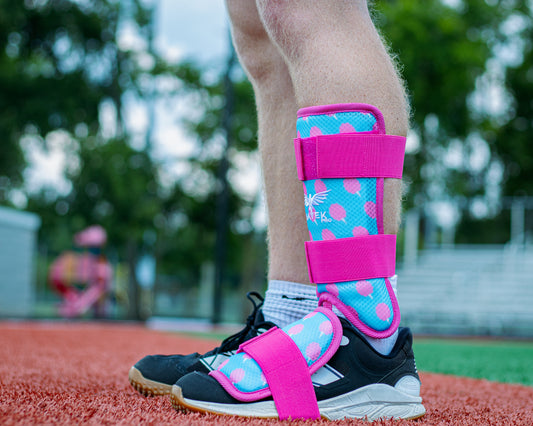 Person wearing colorful protective gear on a sports field